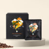 Cohoma Cinnamon Hazelnut Drip Coffee Bag with accompanying box, showcasing the vibrant packaging design with fresh Coffee.