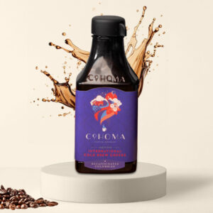 Cohoma Decaffeinated Colombian Cold Brew Coffee bottle front with splashing coffee, featuring ready-to-drink cold brew with rich Colombian flavor.