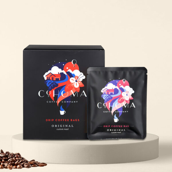 Cohoma Original Custom Roast Drip Coffee Bag with accompanying box, showcasing the vibrant packaging design with a fresh coffee blend.