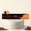 Cohoma Cinnamon Hazelnut Coffee Capsules box displayed with a single capsule placed on top, showcasing the sleek packaging and branding.