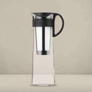 Hario Mizudashi cold brew coffee maker with a sleek glass design and black handle, designed for brewing smooth and refreshing cold coffee, displayed on a neutral beige background