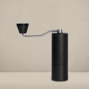 Timemore Chestnut C2 hand grinder in matte black with a sleek stainless steel handle, designed for precise coffee grinding, displayed on a neutral beige background